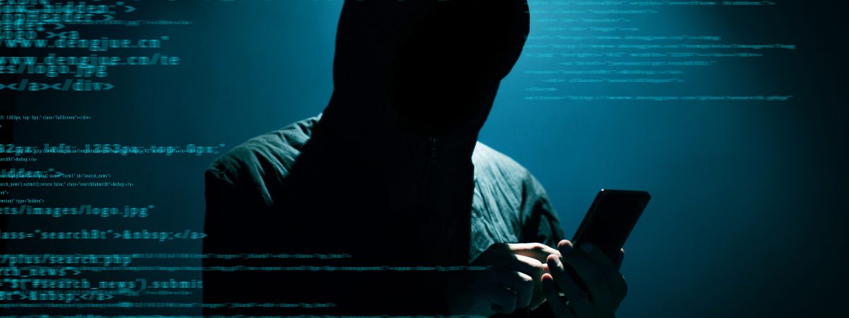 Hacker Hacker using phone at dark