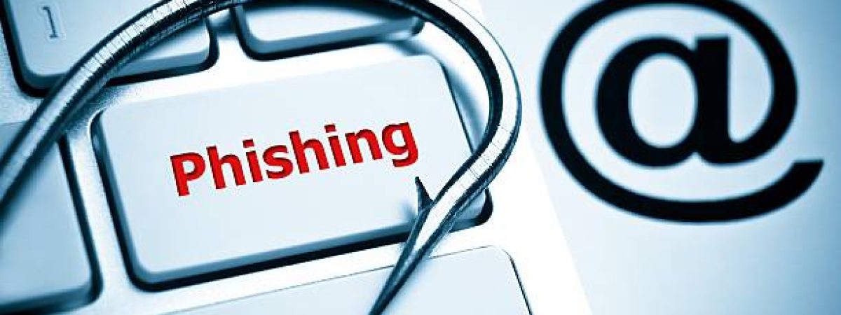 phishing / a fish hook on computer keyboard with email sign / computer crime / data theft / cyber crime